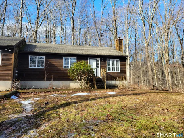 a view of a house with backyard porch and sitting area
