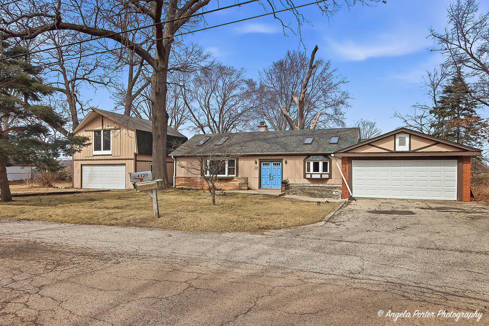 4320 West Lakewood Road McHenry, IL 60050 - Photo 1 of 50 a front view of a house with a yard and garage