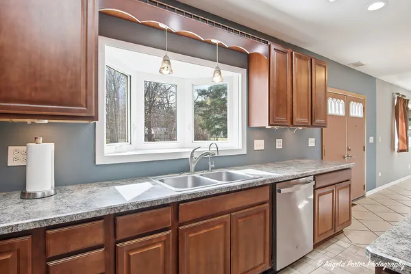 a kitchen with granite countertop a sink and a window
