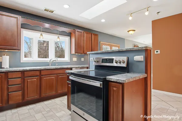 a kitchen with stainless steel appliances granite countertop a sink and a stove