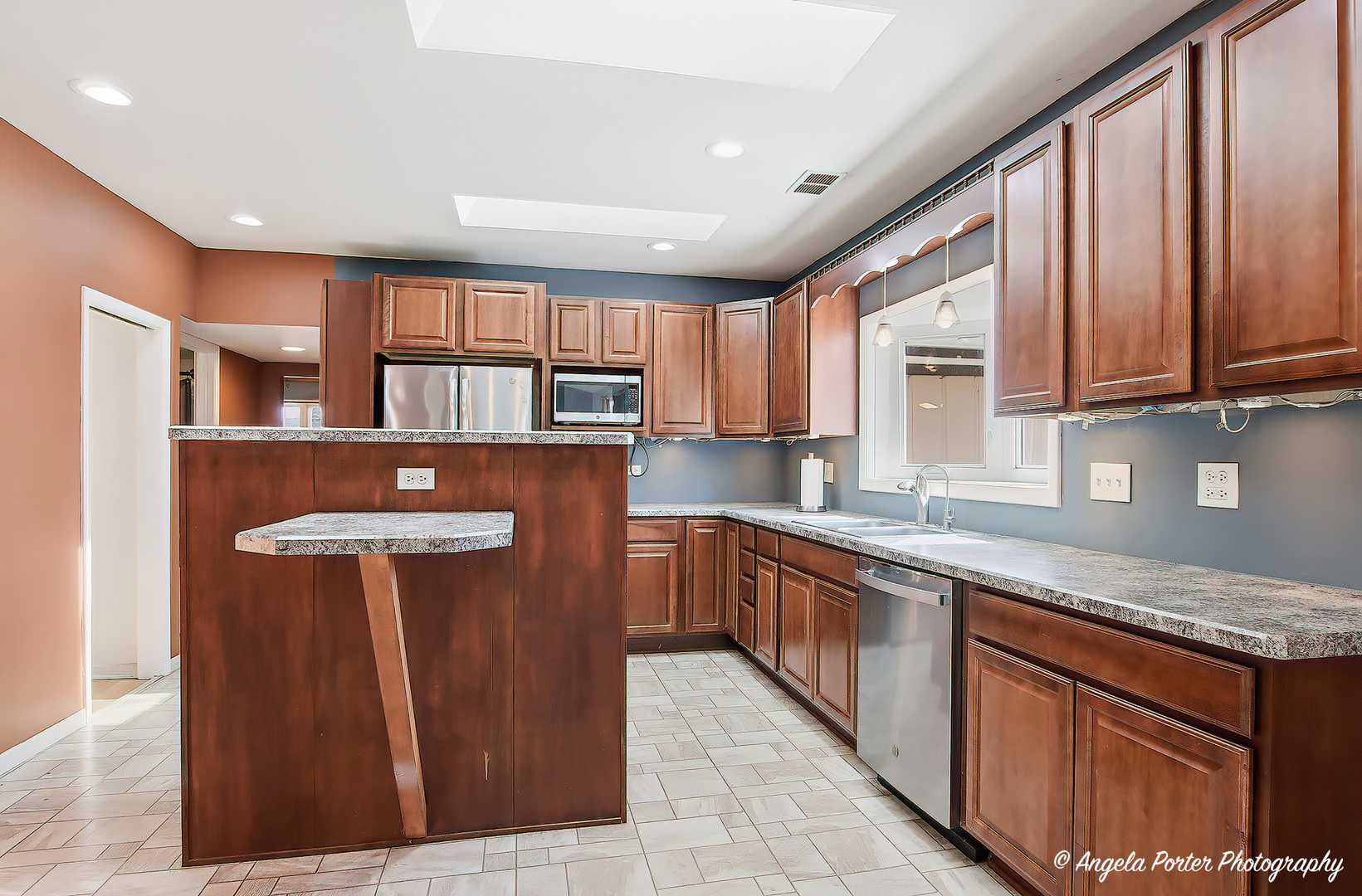 4320 West Lakewood Road McHenry, IL 60050 - Photo 17 of 50 a kitchen with stainless steel appliances granite countertop wooden cabinets a sink and a stove