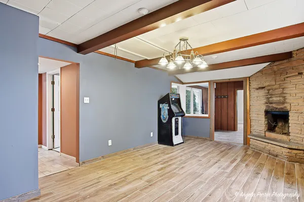 a view of a livingroom with a fireplace and wooden floor
