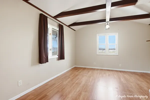 a view of an entryway with wooden floor