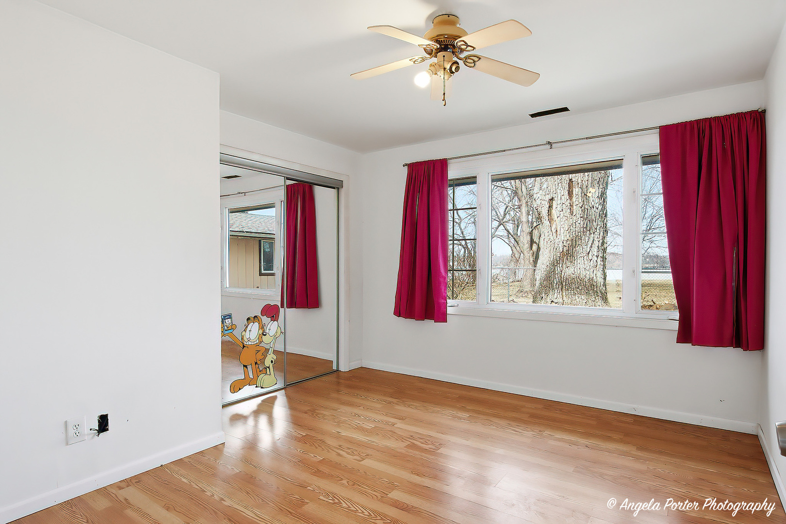 4320 West Lakewood Road McHenry, IL 60050 - Photo 28 of 50 a view of an empty room with a window and wooden floor