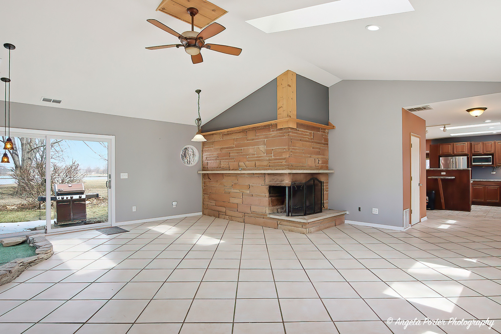 4320 West Lakewood Road McHenry, IL 60050 - Photo 8 of 50 a view of a livingroom with a fireplace cabinets and wooden floor