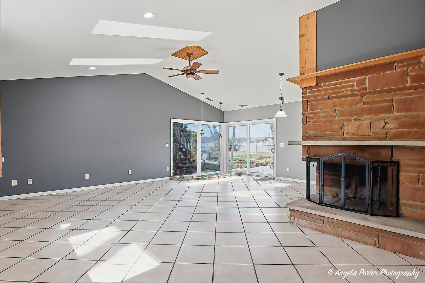 4320 West Lakewood Road McHenry, IL 60050 - Photo 9 of 50 a view of an empty room with a fireplace and a window