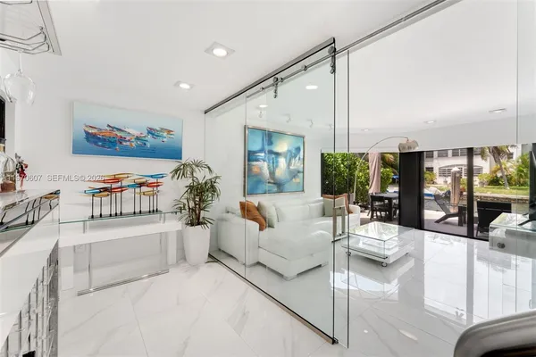 a living room with furniture large window and a flat screen tv