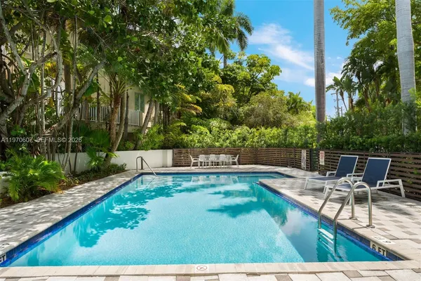 a view of a swimming pool with chairs