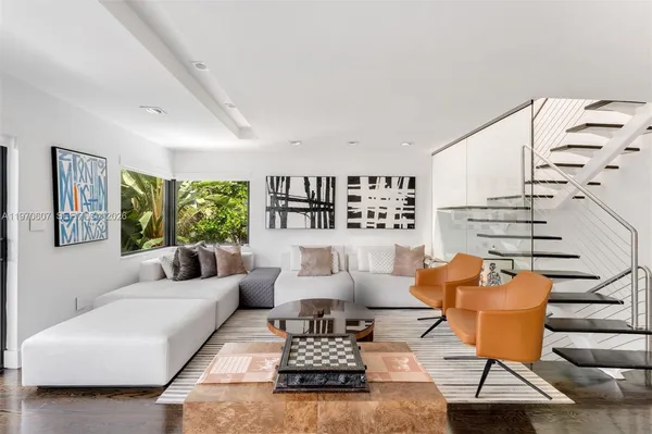 a living room with furniture and wooden floor