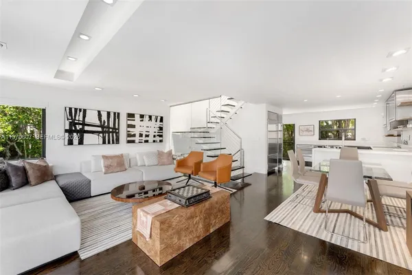 a living room with furniture wooden floor and a table
