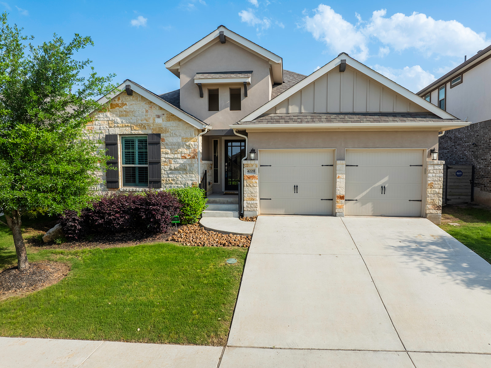 a front view of a house with a yard and garage