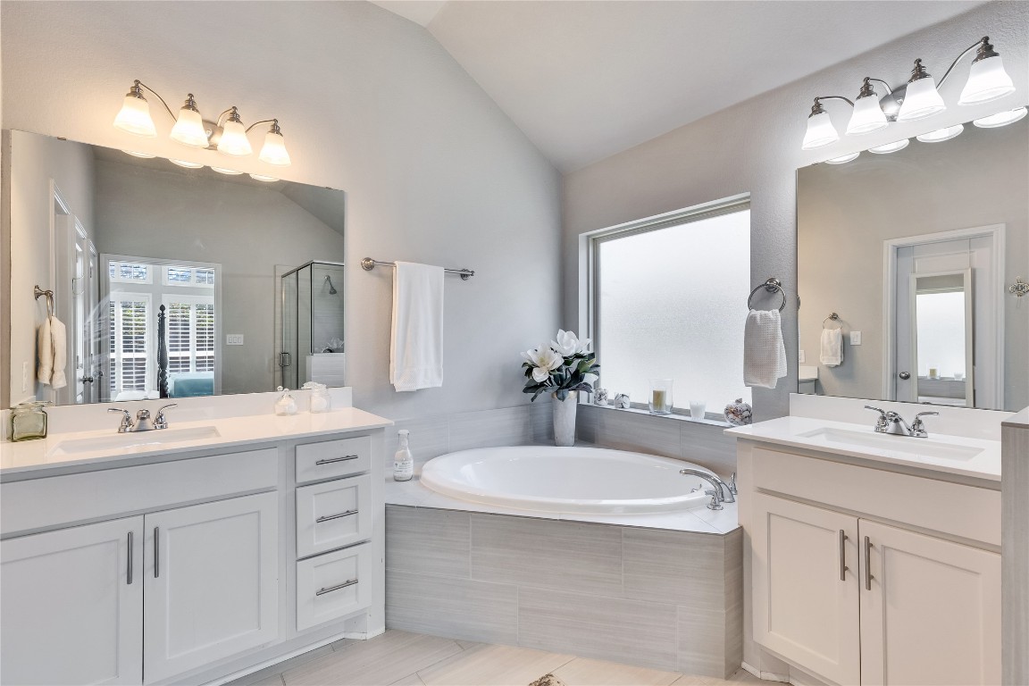4229 Mercer Road Georgetown, TX 78628 - Photo 19 of 38 Full bath featuring a sink, a bath, a stall shower, and vaulted ceiling