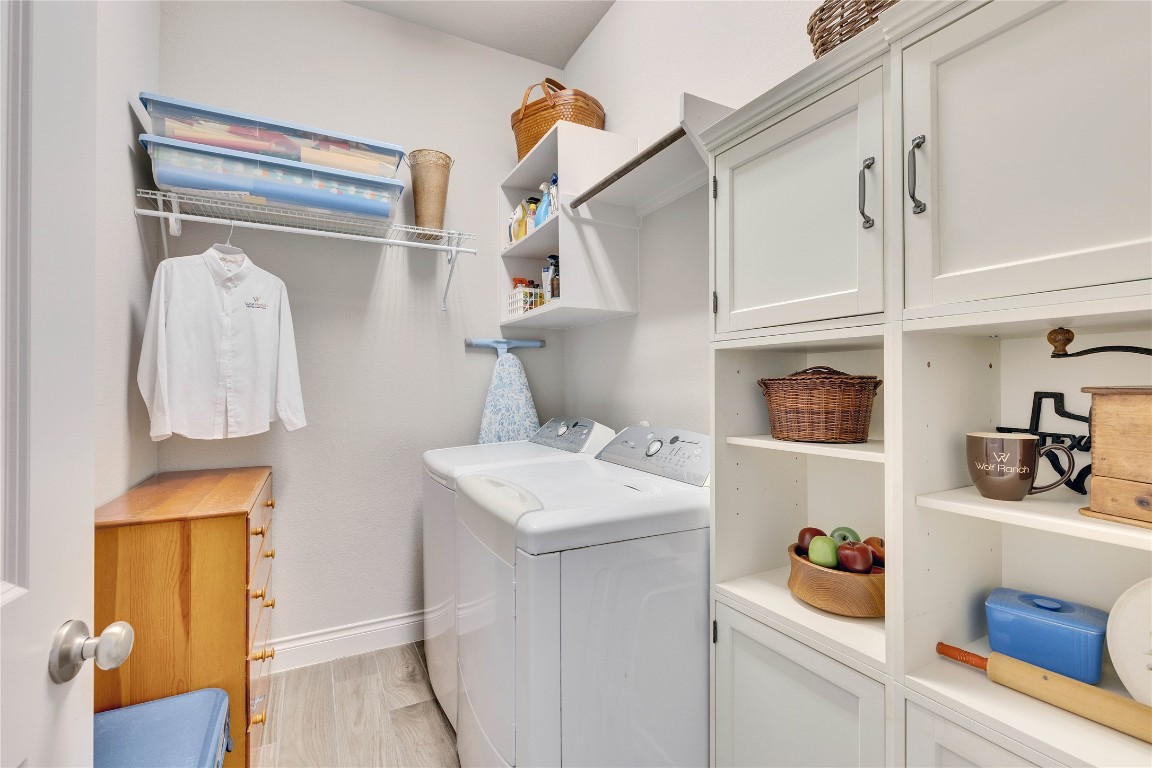 4229 Mercer Road Georgetown, TX 78628 - Photo 20 of 38 Laundry room with baseboards, cabinet space, and washing machine and clothes dryer