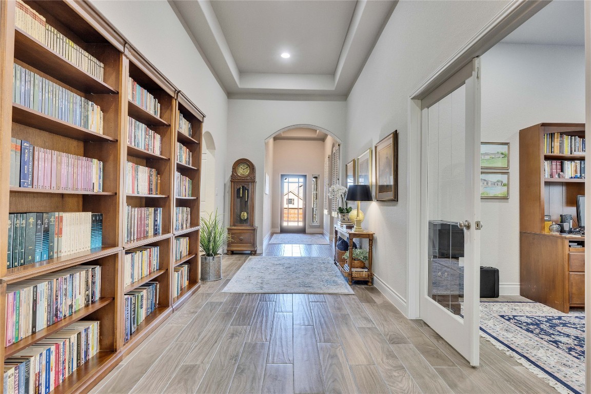 4229 Mercer Road Georgetown, TX 78628 - Photo 22 of 38 Foyer featuring light wood-style floors, arched walkways, baseboards, and a towering ceiling
