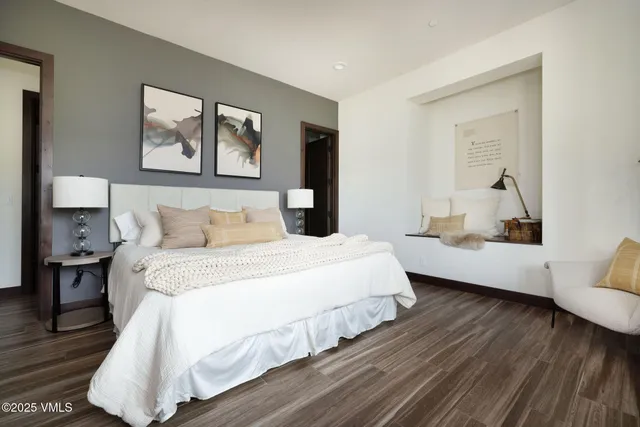 a bed sitting in a bedroom next to a window