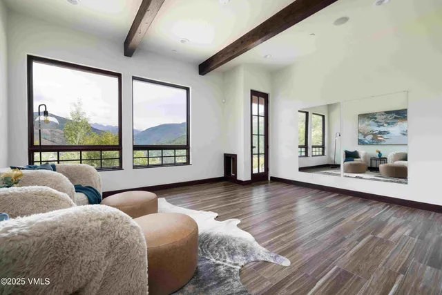 a kitchen with a stove a refrigerator and wooden floor