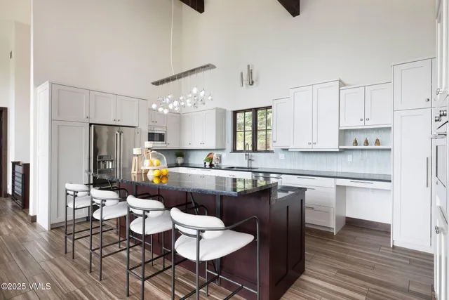 a large kitchen with a table and chairs