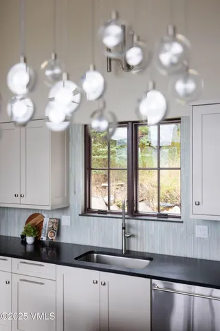 a kitchen with a cabinets and chandelier