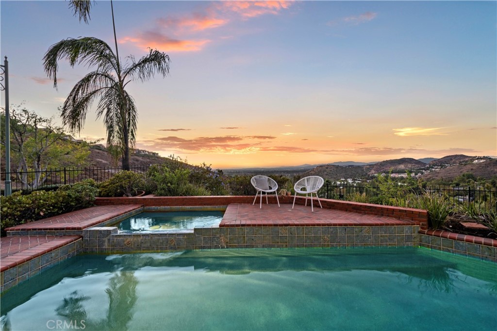 a view of swimming pool with a table and chairs
