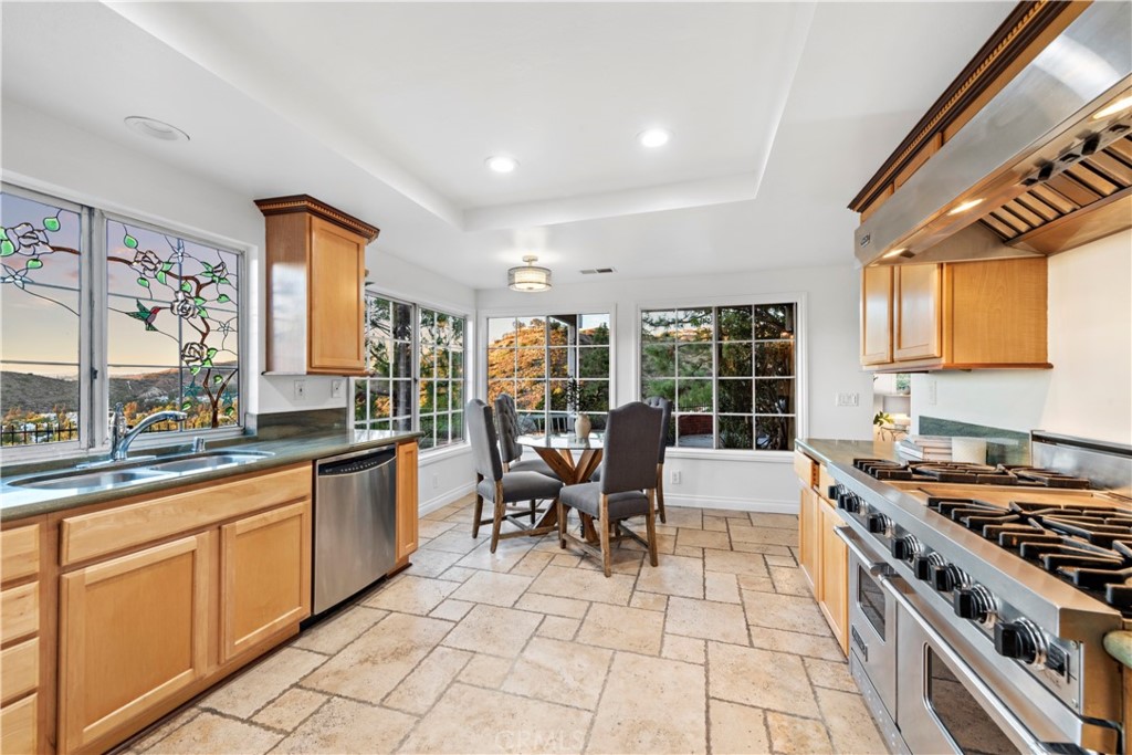 6129 East Joan D Arc Circle Orange, CA 92869 - Photo 11 of 27 a kitchen with stainless steel appliances granite countertop a stove a sink and a microwave