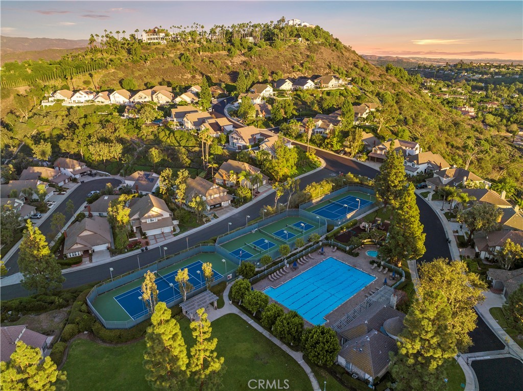 6129 East Joan D Arc Circle Orange, CA 92869 - Photo 14 of 27 Rocking Horse Ridge Estates features a 24-hr guard gate, Jr Olympic pool and spa, clubhouse, playground, large grass area, two tennis courts and two pickleball courts.