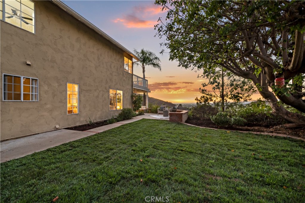 6129 East Joan D Arc Circle Orange, CA 92869 - Photo 17 of 27 a view of a backyard with plants and a large tree