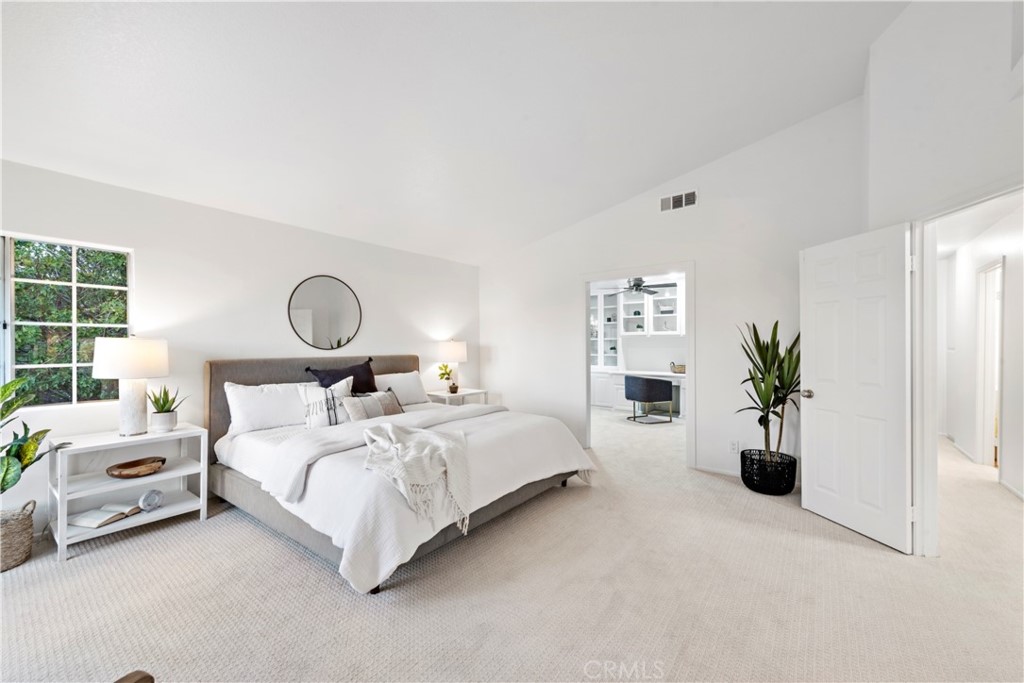 6129 East Joan D Arc Circle Orange, CA 92869 - Photo 19 of 27 a bedroom with a bed and potted plant