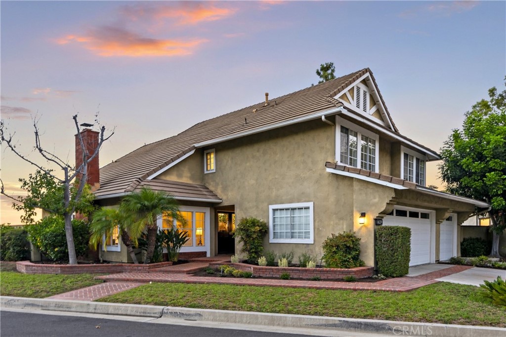 6129 East Joan D Arc Circle Orange, CA 92869 - Photo 3 of 27 a front view of a house with a yard