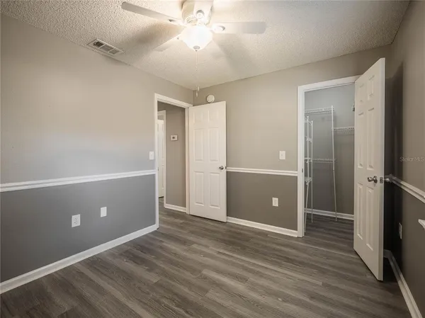 a view of an empty room with wooden floor
