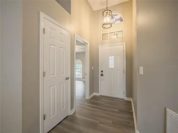 a view of a hallway with wooden floor