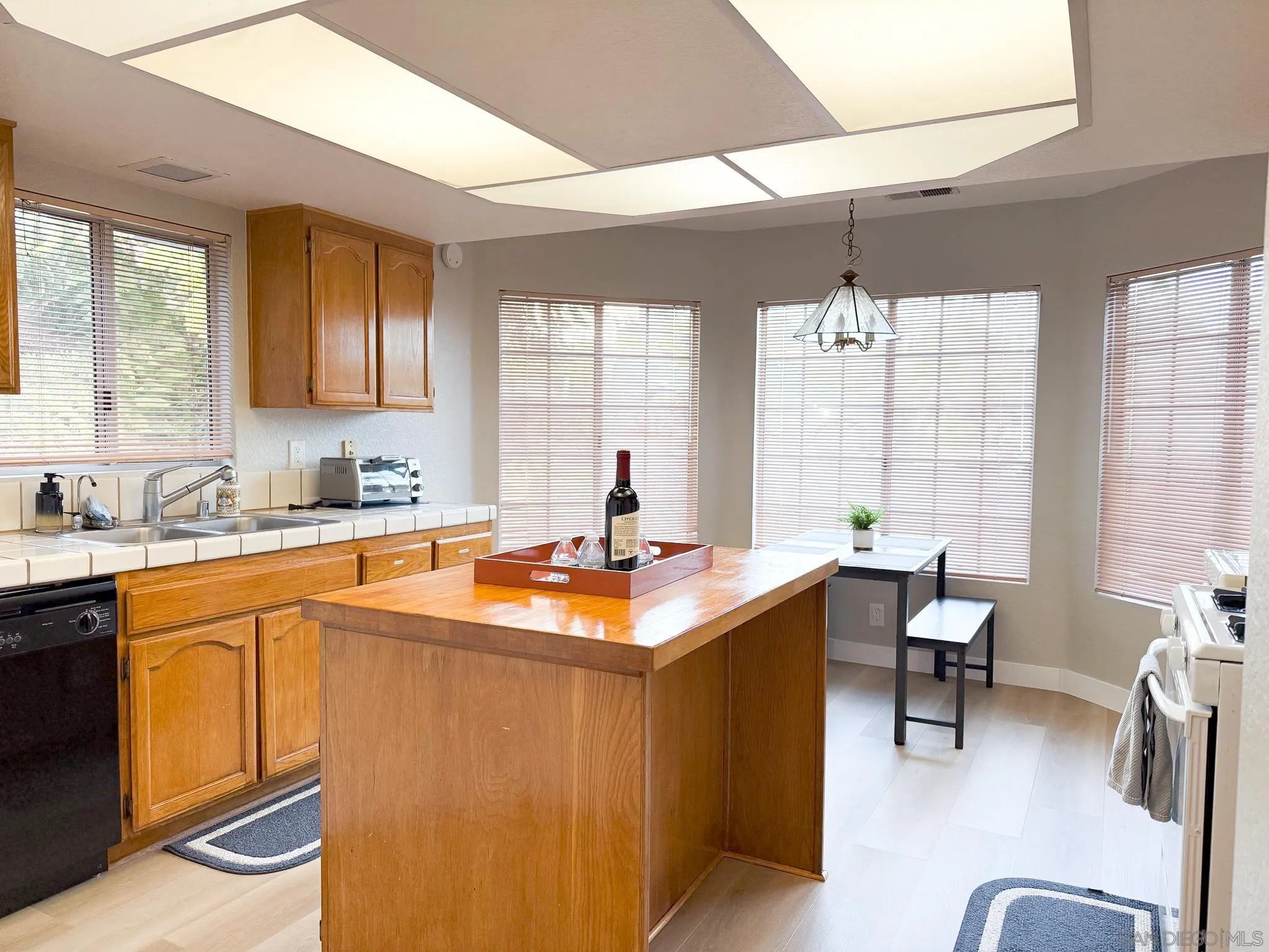 1457 Fallsview Place Escondido, CA 92027 - Photo 16 of 41 a kitchen with stainless steel appliances granite countertop sink stove and wooden cabinets