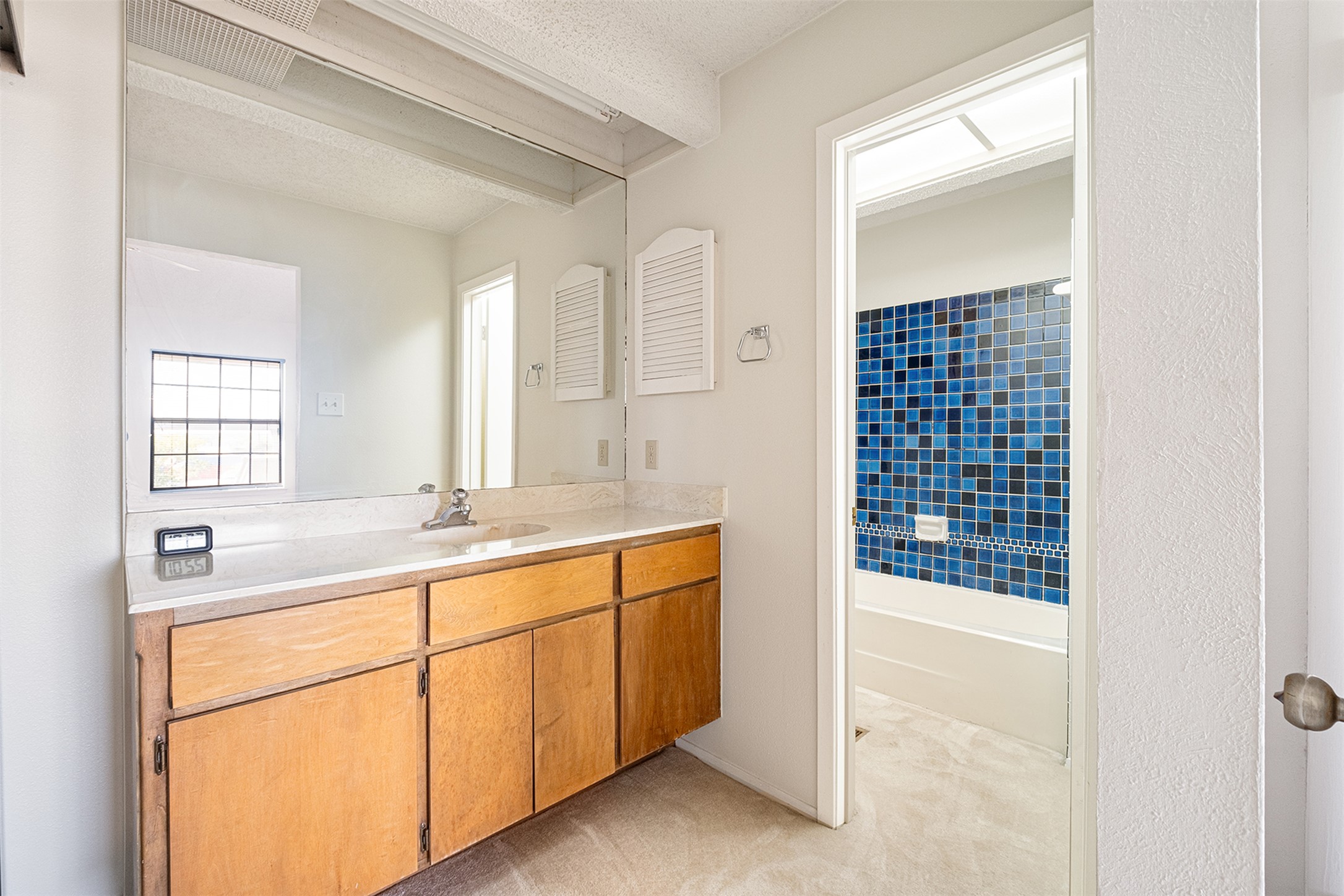 1748 Ohlen Road, Unit 16 Austin, TX 78757 - Photo 29 of 38 Bathroom featuring vanity, light carpet, a textured ceiling, and shower / washtub combination