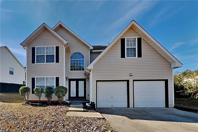 a front view of a house with a yard