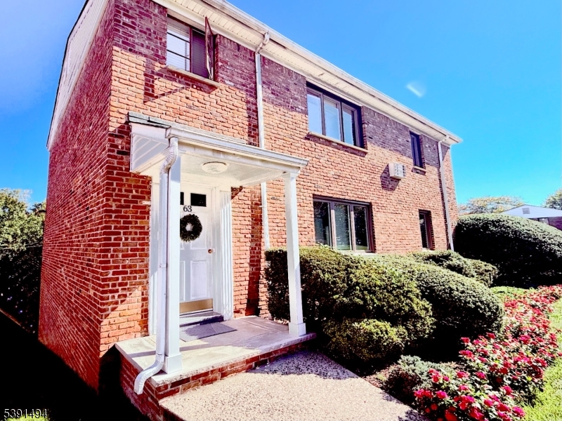 63 Troy Drive, Unit A Springfield, NJ 07081 - Photo 2 of 8 a front view of a house with a yard