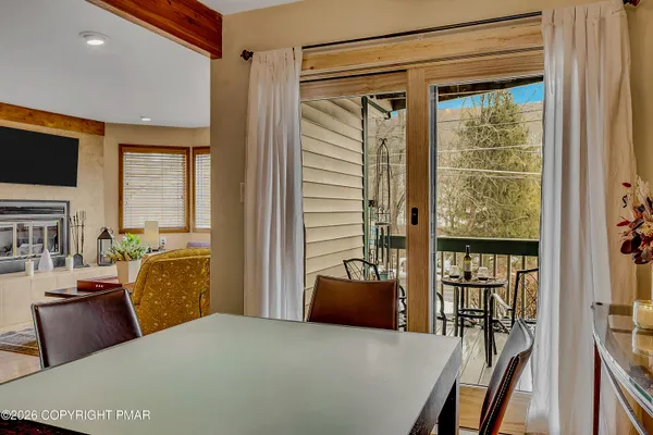 a bedroom with a bed and glass door