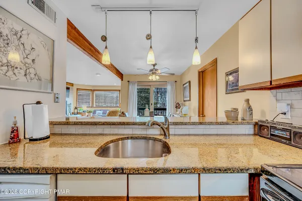 a kitchen with a sink a counter and cabinets