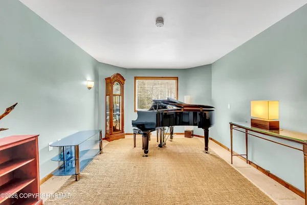 a view of a livingroom with furniture and a flat screen tv