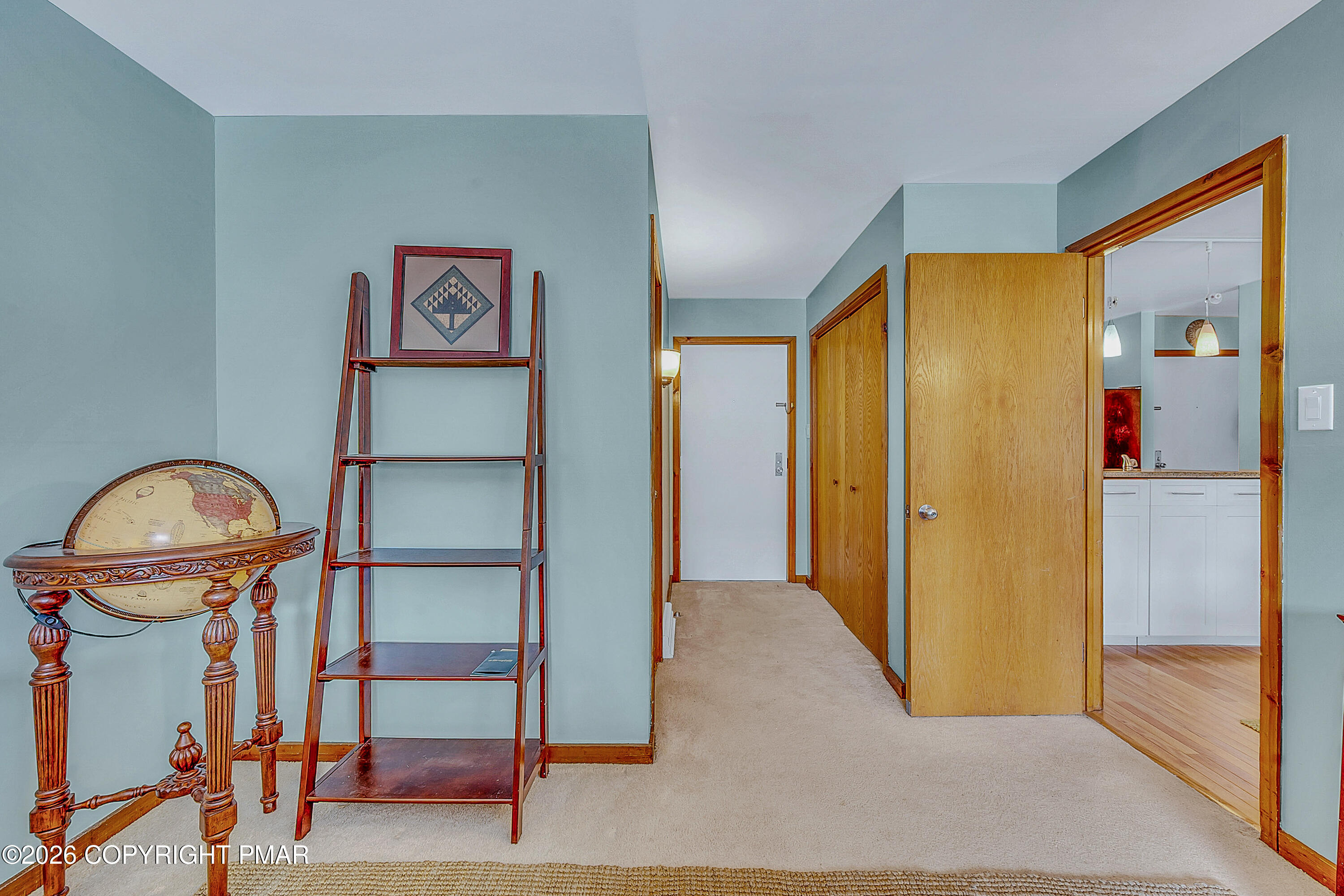 312 Hollow Road, Unit 36 East Stroudsburg, PA 18302 - Photo 19 of 34 a view of a hallway with paintings on the wall