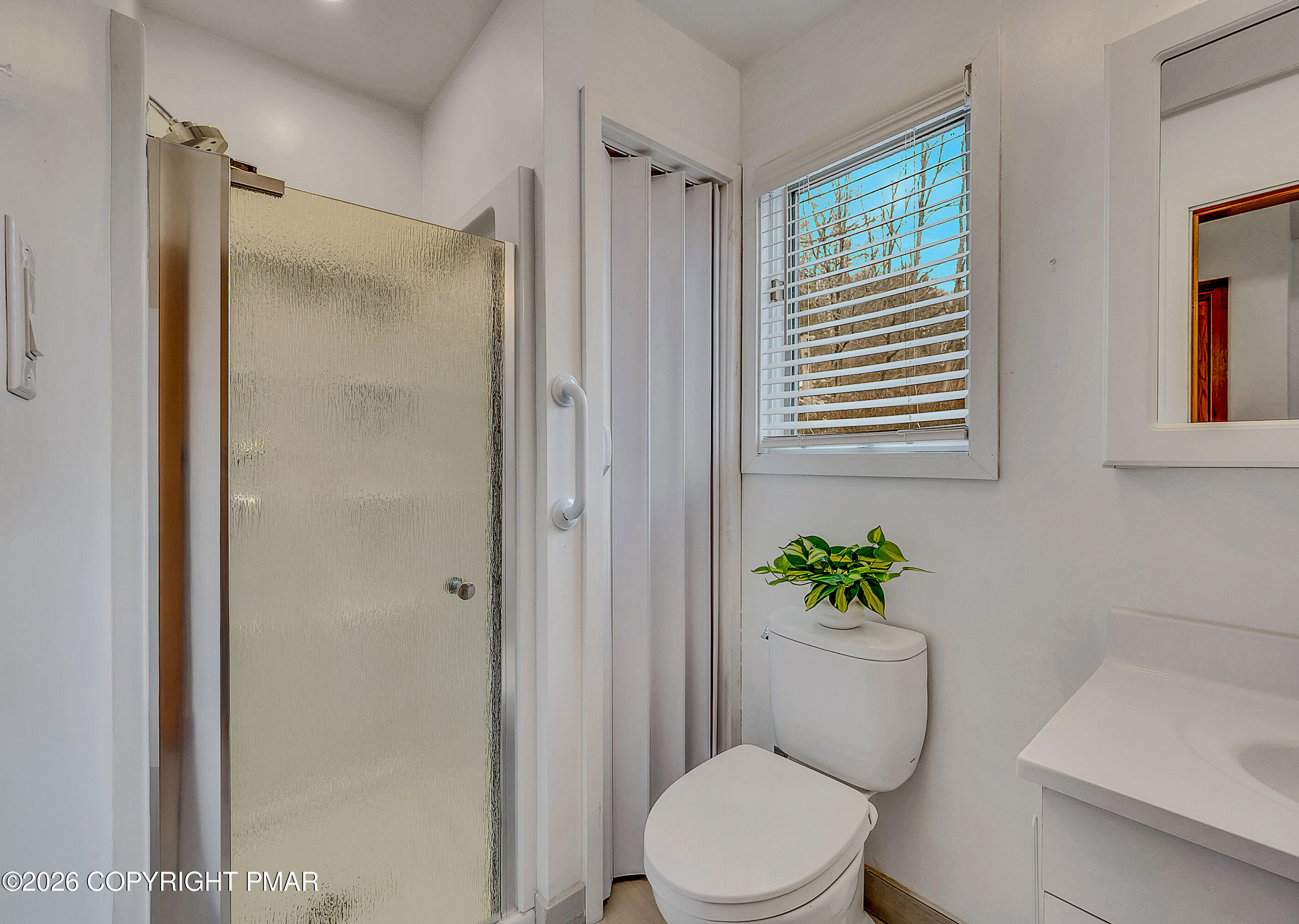 312 Hollow Road, Unit 36 East Stroudsburg, PA 18302 - Photo 25 of 34 a white toilet sitting next to a bathroom sink and vanity