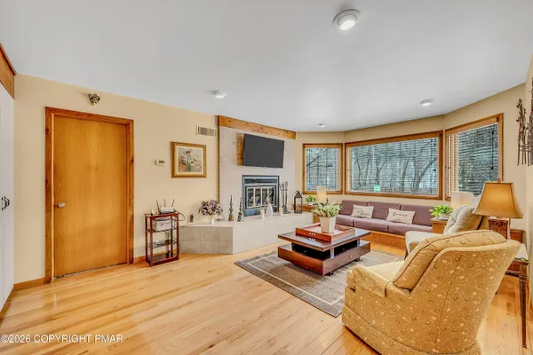 a living room with furniture large window and flat screen tv