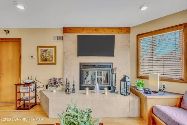 a living room with fireplace furniture and a flat screen tv