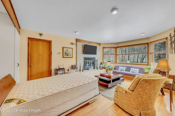 a bedroom with furniture and large windows