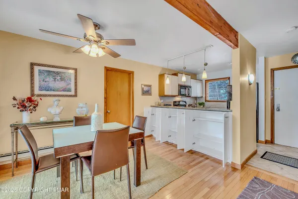 a view of a dining room with furniture and wooden floor