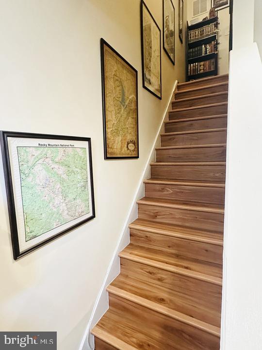 1520 Constitution Avenue Northeast Washington, DC 20002 - Photo 14 of 26 a view of staircase with wooden floor and windows