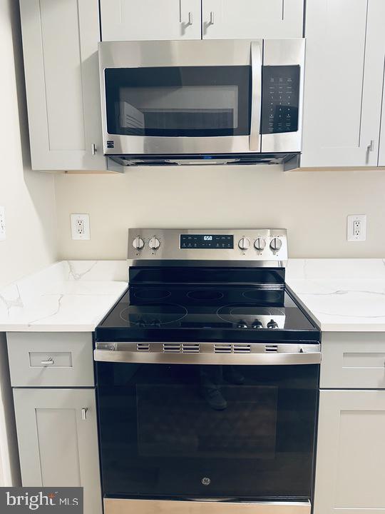 1520 Constitution Avenue Northeast Washington, DC 20002 - Photo 7 of 26 a kitchen with stainless steel appliances a stove and a microwave