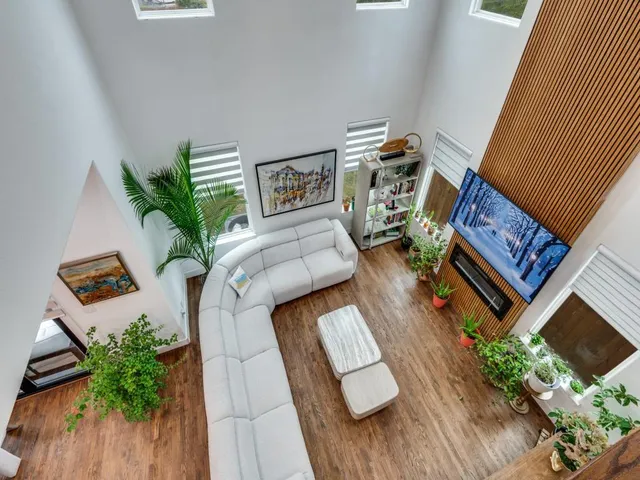 a living room with furniture and a potted plant