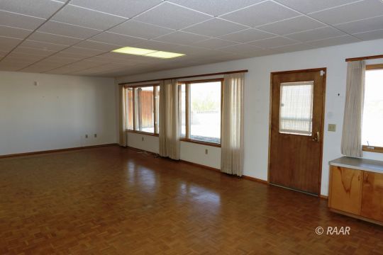 237 North Alford Street Ridgecrest, CA 93555 - Photo 7 of 35 a view of an empty room with a window and wooden floor