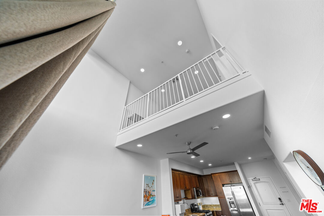 629 Traction Avenue, Unit 233 Los Angeles, CA 90013 - Photo 12 of 41 a view of staircase and kitchen with stainless steel appliances