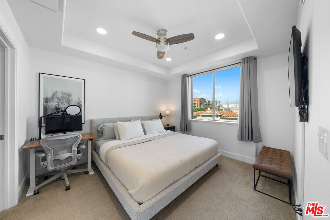 629 Traction Avenue, Unit 233 Los Angeles, CA 90013 - Photo 21 of 41 a bedroom with a bed and a chandelier