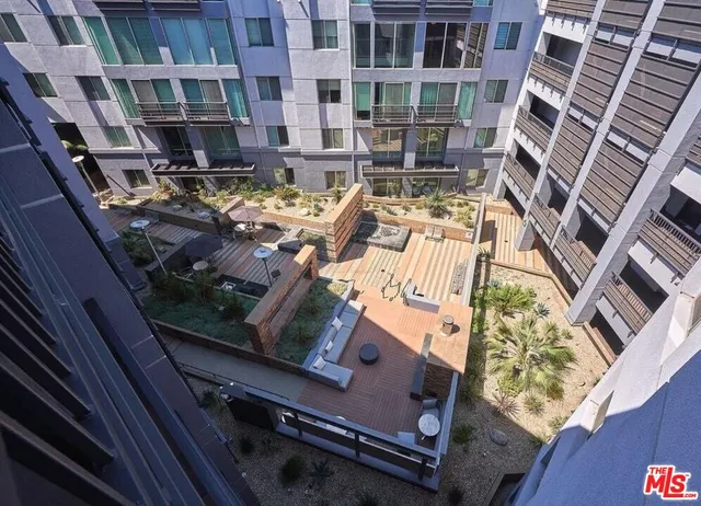 a view of a patio with couches chairs and a fireplace